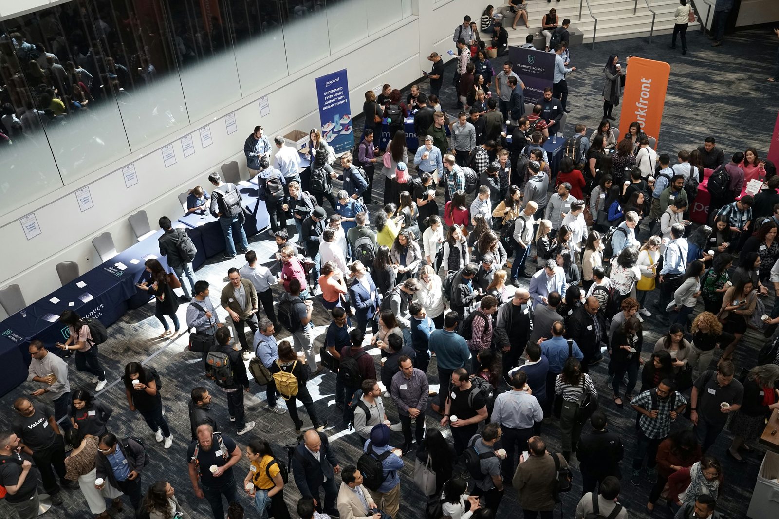 Hundreds of attendees networking at a large-scale event
